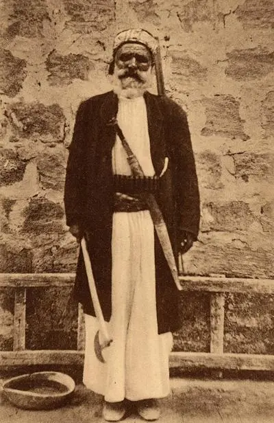 Alawiteman — An Alawite man in Latakia, early 20th century. A post card from around 1900 of an Alawite man posing with his hatchet, sword, and rifle. Alawites, populate mainly the…
